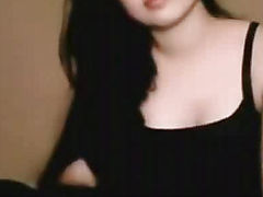 Beautiful Indian woman with long black hair in her robe sitting on a bed - 2