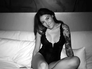 Irresistible milf posing in sexy black lingerie on the bed