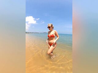 A sexy girl Lovita Fate playing on the beach in a bikini