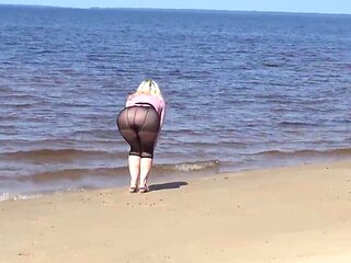 Jokey cougar with nylon caboose and breasts on beach