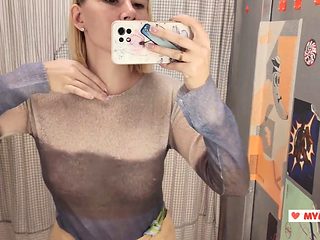 Hot blonde tries on transparent clothes in a mall fitti...