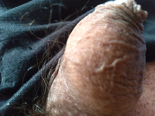 young boy massages his dirty penis