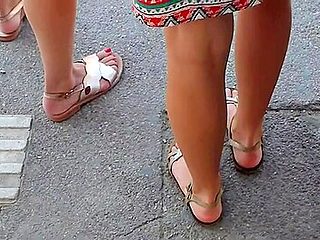 Beautiful Legs And Feet In Sandals Of Two Attractive Yo...