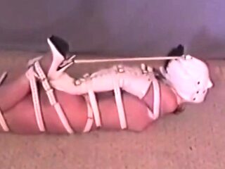 Hogtied Ashley struggling on the floor