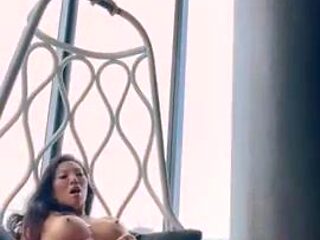 Exotic seductress poses naked and fingers her smooth pussy