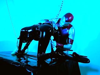 Rubber slut in chain bondage