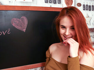 Pale redhead with an amazing figure is fingering herself